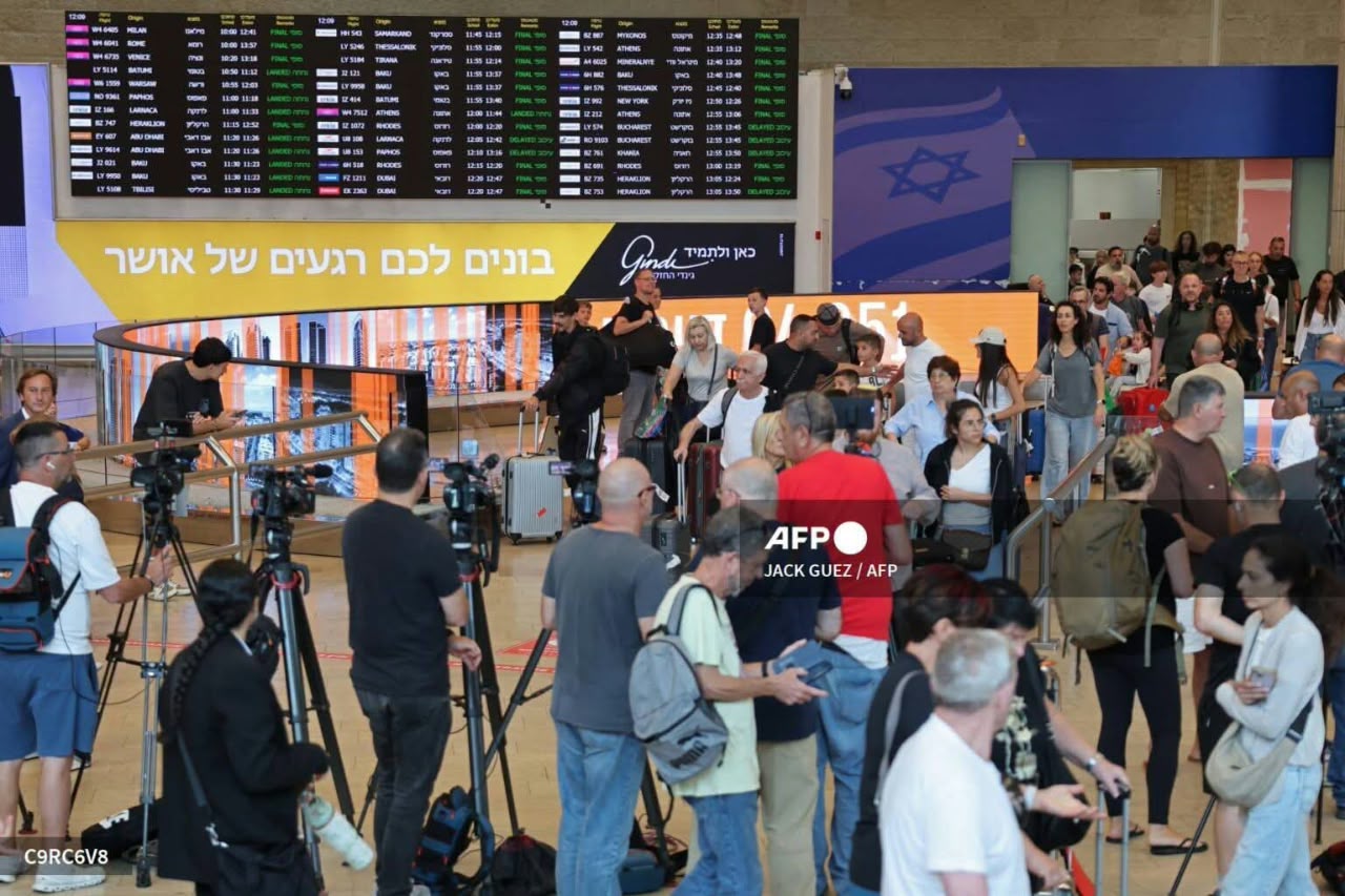 Media representatives gather along with passengers at the Ben Gurion Airport near Tel Aviv on September 30, 2026. A flydubai plane bound for Tel Aviv was forced to land in Saudi Arabia on September 30 after an "incident", the airline said, with Israeli media reporting an altercation between the pilots. (Photo by Jack GUEZ / AFP)