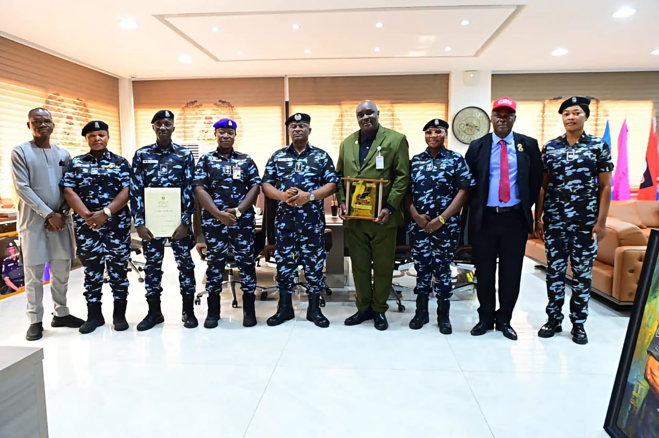 IGP Tunji Disu in a group photograph with the trained officers 